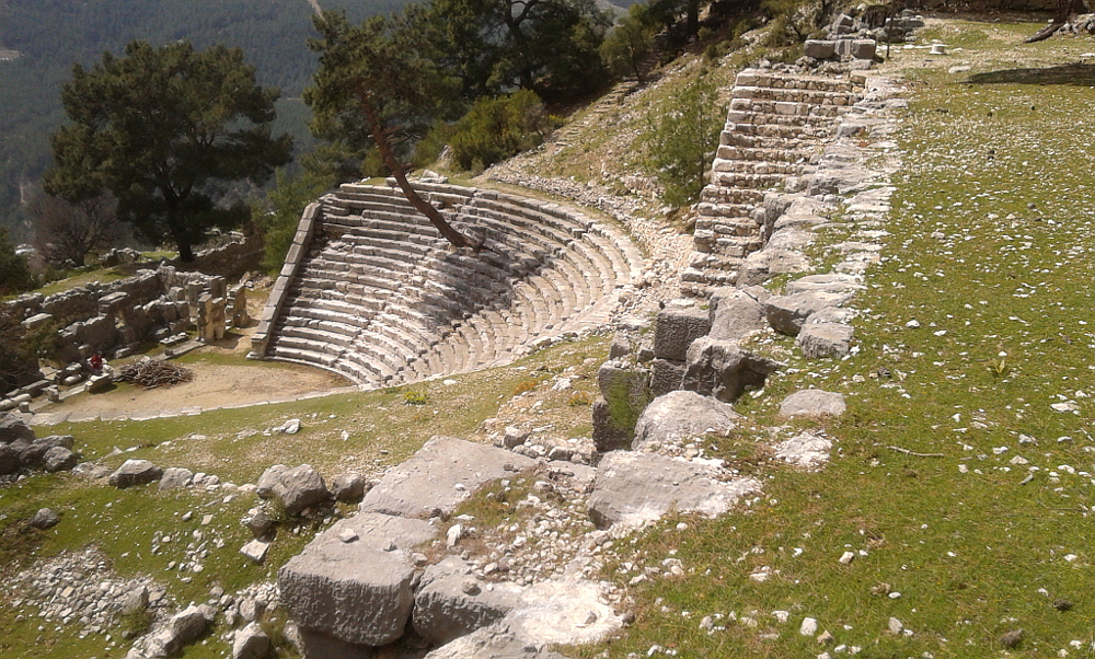 The theatre is below the open side of the half stadium. Note the tree growing out of the seating